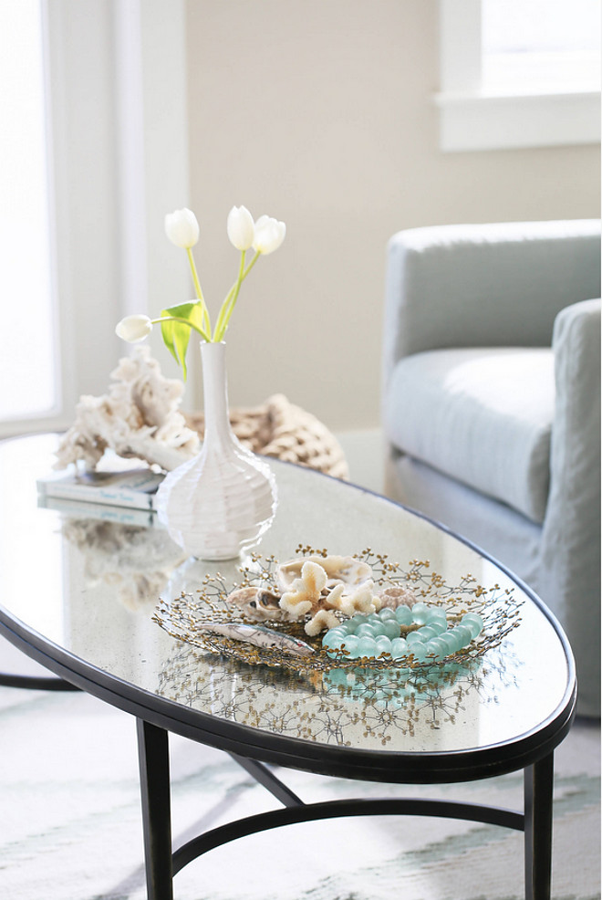 Coffee Table Decor. I needed a skinny coffee table for the small space so I went for a surf board shape to keep to the coastal feel. It's a metal base, antique mirrored top to reflect more light! Coastal Coffee Table Decor. Coffee Table Decor Ideas #CoffeeTableDecor #CoastalCoffeeTableDecor #CoffeeTableDecorIdeas JoAnn Regina Home
