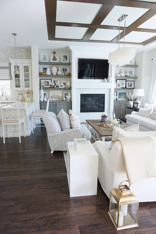 Family room and kitchen. Family room and kitchen. The fireplace centers the space - surrounded by a carrara marble tile and white trim and mantle. For the ceiling, we added some drama with installing wood paneling stained in a dark expresso. Family room and kitchen. Family room and kitchen. Family room and kitchen. Family room and kitchen. Family room and kitchen #Familyroom #kitchen Beautiful Homes of Instagram @MyHouseOfFour