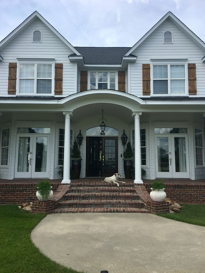 Farmhouse. Our house is truly a Southern farm house. The exterior paint color is Benjamin Moore White. White Hardie Board siding, with hand made cypress shutters. The brick is solid and is made in molds by hand to look like old brick the name is Orleans. #farmhouse