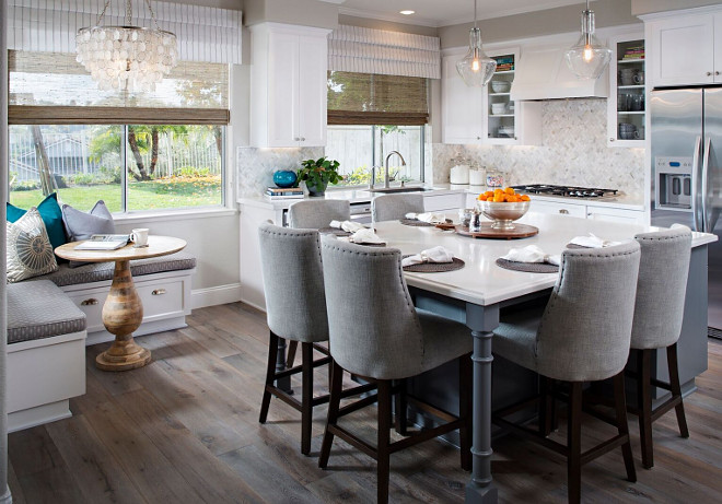 Kitchen island with four seating and corner nook with built-in banquette. The clients for this kitchen have 3 small children and wanted a family-friendly space where their kids and friends could hang out, complete homework, etc. Clients wanted kid friendly but a very “grown up” looking kitchen, so we added the herringbone marble backsplash, capiz chandelier and glass pendants. All of the fabrics used are indoor/outdoor for easy cleaning. Kitchen island with four seating and corner nook with built-in banquette ideas. Kitchen island with four seating and corner nook with built-in banquette #Kitchenisland #kitchen #fourseatingisland #cornernook #builtinbanquette Tracy Lynn Studio