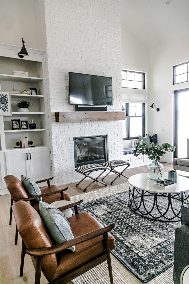 Modern Farmhouse Brick Fireplace. Farmhouse Brick Fireplace. The painted brick fireplace is the focal point of the family room. Warmth was introduced into the space with the addition of a custom made white oak mantel. The mantel was given a custom stain, which compliments the other wood tones in the home. #FixerUppper #MagnoliaMarket #Farmhousestyle Sita Montgomery Interiors