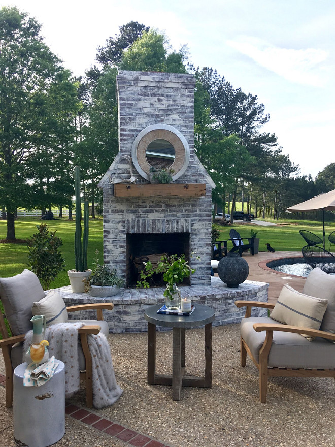 Outdoor Brick Fireplace. Outdoor Brick Fireplace with whitewash. The mantel is a beam my husband had made out of cypress! We enjoy setting here with a fire on a cool night! Outdoor Brick Fireplace ideas Outdoor Brick Fireplace Whitewash #OutdoorBrickFireplace #OutdoorFireplace #BrickFireplace #whitewashbrick #OutdoorBrickFireplaceideas #OutdoorBrickFireplaceWhitewash Beautiful Homes of Instagram @cindimc.ivoryhome