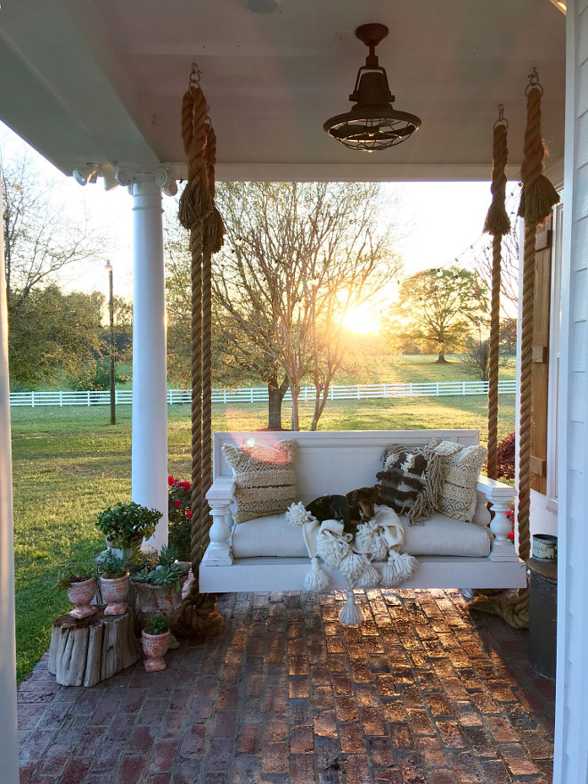 Porch with swing bed. Porch with swing bed with rope. We had the swing built, it is built out of a door from the 1800's! Brick Porch with swing bed. #Porch #swingbed #brickporch #brick Beautiful Homes of Instagram @cindimc.ivoryhome