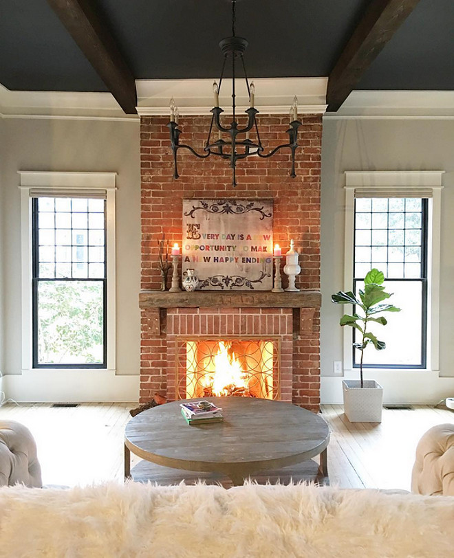 Reclaimed Brick Fireplace. This farmhouse features an original reclaimed brick fireplace. Chandelier: Currey & Company Conversation French Black Eight-Light Chandelier Reclaimed Brick Fireplace. Reclaimed Brick Fireplace. Reclaimed Brick Fireplace. Reclaimed Brick Fireplace #ReclaimedBrickFireplace