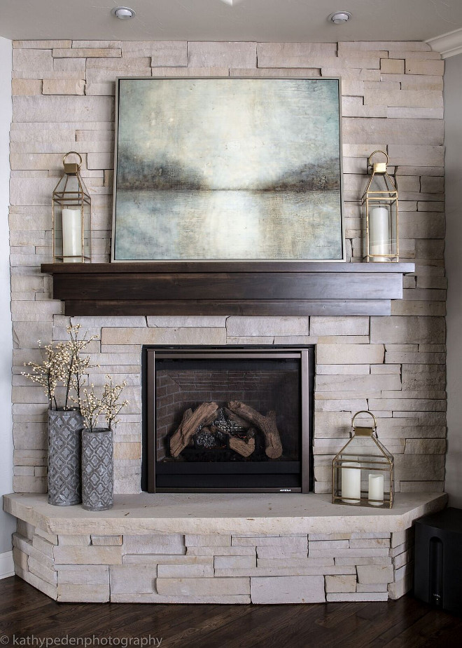 Stone Fireplace. The living room features a corner stone fireplace with Black Walnut mantel. Neutral Stone Fireplace with black walnut stained mantel.Stone Fireplace. Neutral Stone Fireplace with black walnut stained mantel #StoneFireplace #NeutralStone #Fireplace #blackwalnut #stainedmantel Restyle Design, LLC.