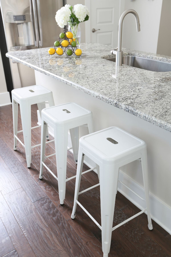 White Granite Countertop. Kitchen with Durable and non-porous White Granite Countertop. Cambridge White Granite. Countertops are a white granite with just a little gray to hold all the whites together. The designer chose the metal counter stools so they could pull up a seat coming home for lunch from the beach. They are perfect for wet bathing suit...someplace to sit without changing. (I wanted the space to be beautiful and livable). White Granite Countertop. White Granite Countertop #WhiteGranite #Countertop #WhiteGraniteCountertop JoAnn Regina Home