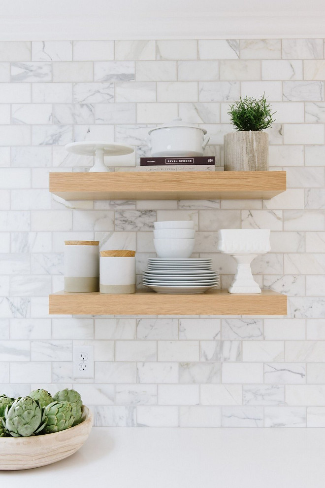 White Oak Floating Shelves. Kitchen with White Oak Floating Shelves against marble backsplash tile and white quartz countertop. White Oak Floating Shelves. Kitchen with White Oak Floating Shelves against calcutta marble backsplash tile and white quartz countertop #WhiteOakshelves #FloatingShelves #Kitchen #WhiteOakFloatingShelves Studio McGee