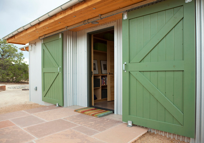 Barn Doors. Modern Farmhouse with barn doors. The patio features cut flagstone. #BarnDoors #ModernFarmhouse #farmhousebarndoors #patio #flagstone Palo Santo Designs LLC