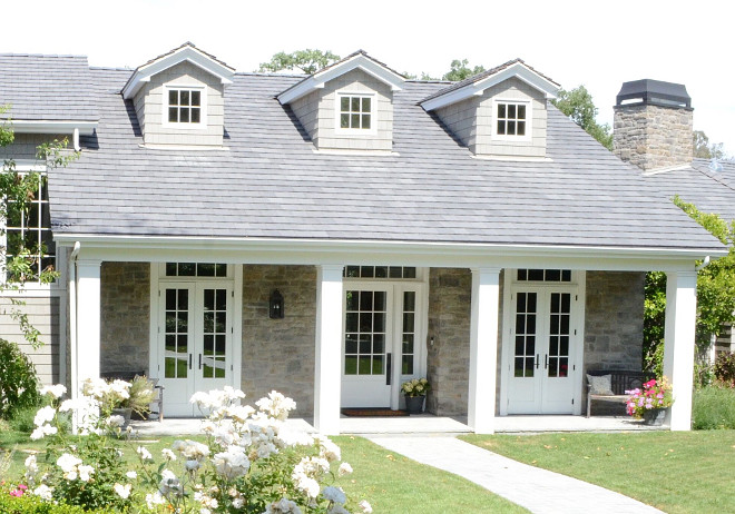 Cape Cod front porch. Cape Cod front porch ideas. We wanted a country cottage feel for the exterior of our home so we chose wood shingles mixed with stone. Stone is Eldorado Stone with over grout. Trim Color is Benjamin Moore Decorator’s White Cape Cod front porch. Stone Cape Cod front porch #CapeCodfrontporch #CapeCod #frontporch #porch #stonecapecod Beautiful Homes of Instagram @SanctuaryHomeDecor