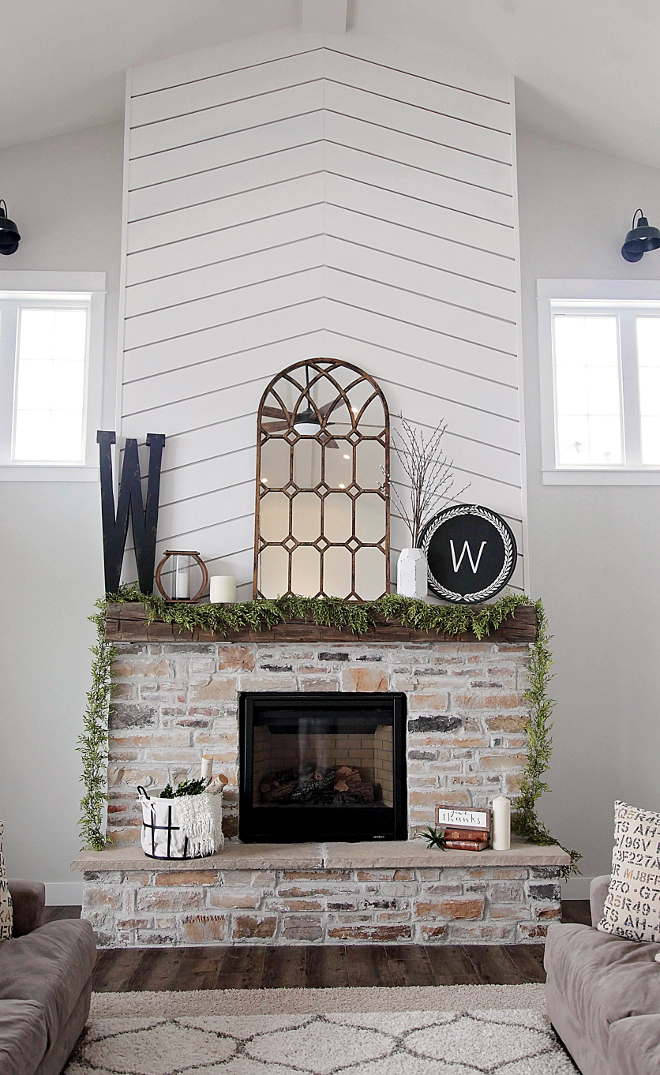 Farmhouse Fireplace with shiplap and brick. I knew I wanted to create something unique and bold with the fireplace so we decided to go with a bold and modern herringbone type pattern wood treatment on the fireplace. We then paired it with a very rustic exposed wood beam and finished it off with some aged stone. We LOVE how it turned out and just adore the modern rustic feel of the room! Farmhouse Fireplace with shiplap and brick Ideas. Farmhouse Fireplace with shiplap and brick. Farmhouse Fireplace with shiplap and brick #FarmhouseFireplace #fireplace #shiplapfireplace #brickfireplace Home Bunch's Beautiful Homes of Instagram @household no.6