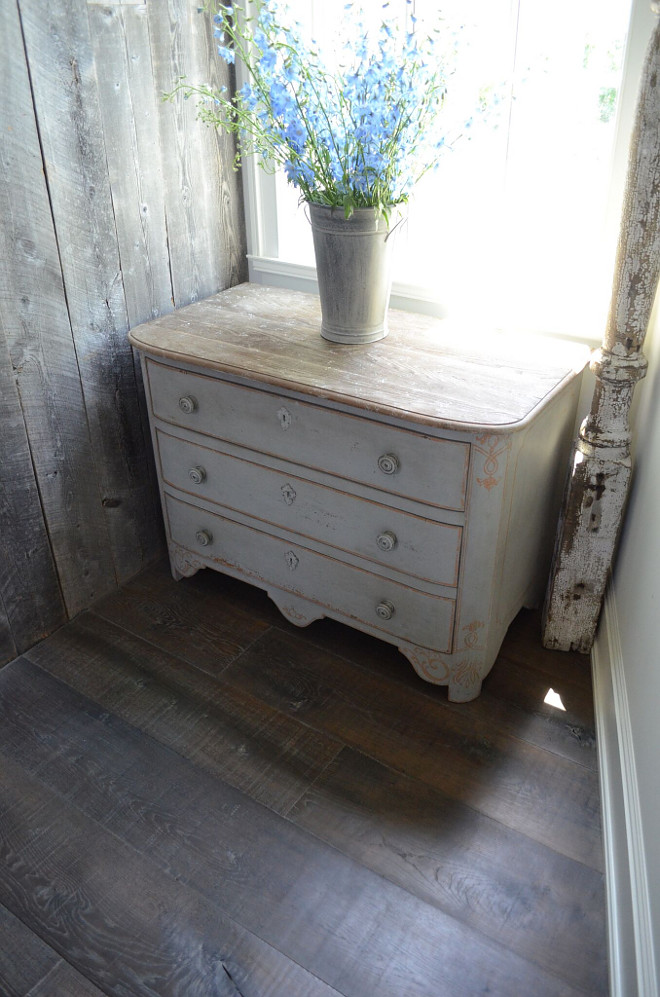 Farmhouse reclaimed shiplap wall paneling and wide plank oak floors. The stair landing showcases the reclaimed wood and the wide plank oak floors Distressed Cabinet is Dovetail Furniture. #Farmhouse #reclaimedshiplap #shiplap #shiplapwallpaneling #reclaimedshiplappaneling #wideplankoakfloors Beautiful Homes of Instagram @SanctuaryHomeDecor