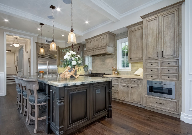 Kitchen Cabinet Glaze. Glazed Kitchen cabinets. The kitchen was 8 steps in order to achieve the depth and interest of the grey finish. The kitchen features custom paneled cabinets, a traditional-style island and coffered ceiling with tongue and groove centers. #KitchenCabinet #cabinetGlaze #GlazedKitchencabinet #Glazedcabinet Brandon Architects, Inc.