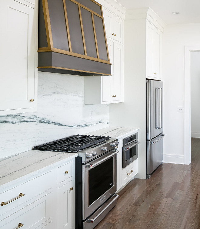 Kitchen Hood. Kitchen hood is MDF with a metallic painted finish in pewter and brass. Cabinets are maple with inset doors. #kitchenhood #pewterkitchenhood #brasskitchenhood #brasshood #pewterhood #interiors #kitchen Ramage Company. Leslie Cotter Interiors