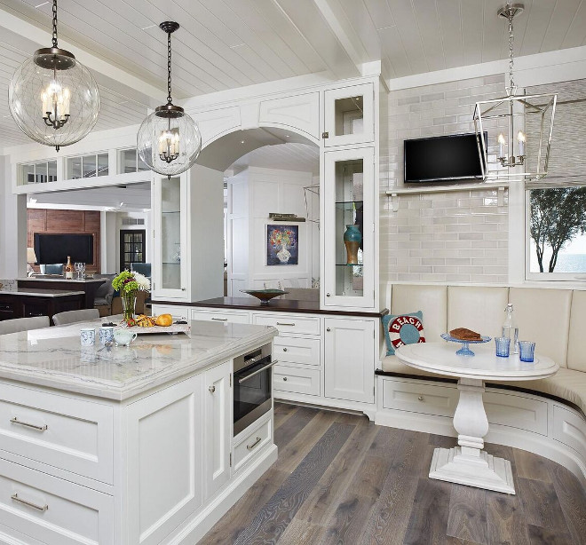 Mixing Lighting Finishes. How to mix metals with lighting. Polished nickel is used on the cabinet hardware and on the breakfast room lighting. This kitchen combines lighting finishes quite well. The polished Darlana lantern contrasts with the bronze glass pendants above the island. The bronze pendants is accentuated by the warm elements found in the space, such as the hardwood floors and the wood countertop. Mixing Lighting Finishes #MixingLighting #LightingFinishes Benchmark Wood & Design Studios - Mike Schaap Builders