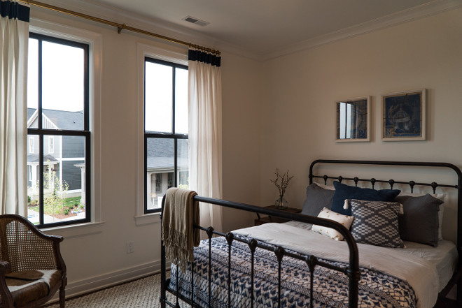 Modern Farmhouse Bedroom with black windows and metal bed. Lovely modern farmhouse bedroom with navy accents. The metal bed is by Four Hands. Modern Farmhouse Bedroom with black windows and metal bed. Modern Farmhouse Bedroom with black windows and metal bed #ModernFarmhouseBedroom #FarmhouseBedroom #blackwindows #bedroomblackwindow #metalbed Ramage Company