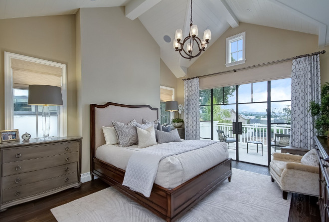 Neutral Tan Bedroom with Vaulted Ceilings. Neutral Tan Bedroom with Vaulted Ceilings. The master bedroom features vaulted ceiling with painted exposed beams and tongue and groove paneling. Black steel doors open to a private balcony. Neutral Tan Bedroom with Vaulted Ceilings #NeutralTanBedroom #TanBedroom #VaultedCeilings Brandon Architects, Inc.