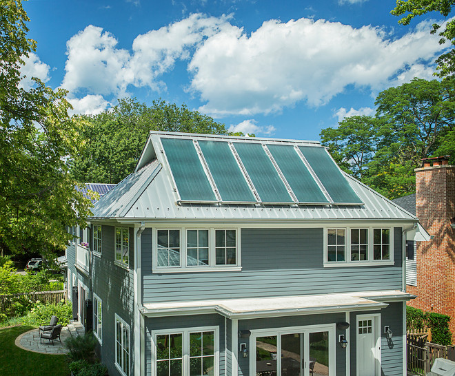 Solar thermal panels. Roof Solar thermal panels. The rear view of the house shows the standing seam metal roof set at an optimal angle for the solar thermal panels. Barely visible to the left is the other roof form, set at a lower angle for the PV panels. The overhangs are designed for winter sun penetration and summer shading. #Solarthermalpanels #RoofSolarpanels Kipnis Architecture + Planning