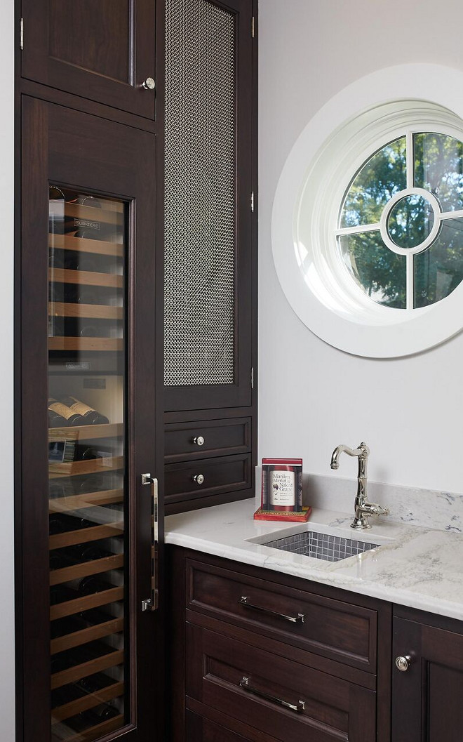 Wet Bar with Dark Cabinet. The wet bar features oversized pulls and dark stained Walnut cabinets. Wet Bar with Dark Cabinetry. Wet Bar with Dark Cabinet. Wet Bar with Dark Cabinet. Wet Bar with Dark Cabinet #WetBar #DarkCabinet #wetbarcabinet Benchmark Wood & Design Studios - Mike Schaap Builders