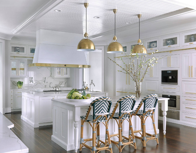 White Kitchen with brass. White kitchen with lots of brass! Brass hardware, brass hood details and brass lighting #whitekitchen #hamptonskitchen #whitekitchenbrass #kitchenbrass #brasshardware #brasshood #brasslighting Mitchell Wall Architecture & Design