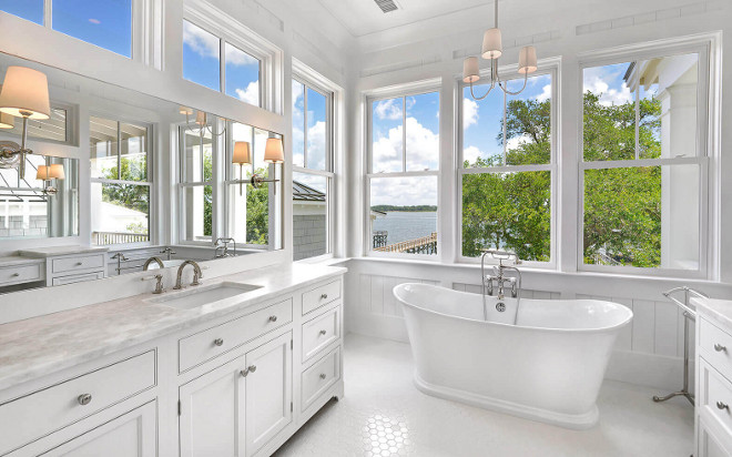 Bathroom features symmetrical sink vanity and makeup vanity. Countertop is Namibia Bright White Marble. Robyn Hogan Home Design