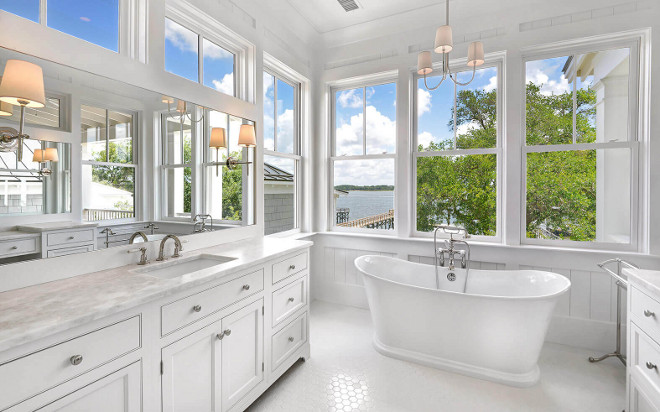 Bathroom features symmetrical sink vanity and makeup vanity. Countertop is Namibia Bright White Marble. Robyn Hogan Home Design