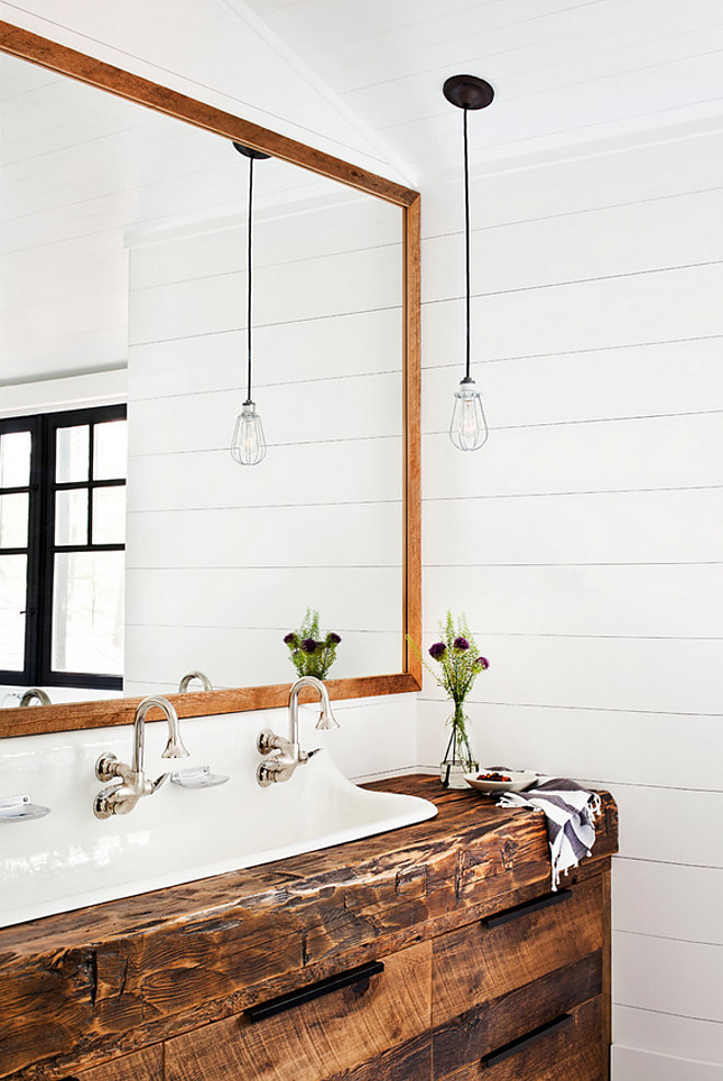 Beam vanity. Beam bathroom vanity. Bathroom features a reclaimed beam washstand fitted with a white trough and two gooseneck faucets tucked under a wood beveled mirror lining a shiplap wall. Reclaimed Beam vanity #Beamvanity #Beam #bathroom #vanity #ReclaimedBeam #bathroomReclaimedBeam Jennifer Worts Design Inc