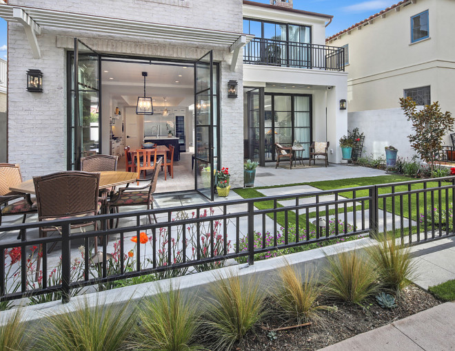 Bronze exterior lanterns from Linden Rose & Co. provide the perfect weight to balance out the windows and doors manufactured by Euroline Steel Windows. The matching pendant in the dining room manufactured by Linden Rose & Co ties the indoor and outdoor spaces together creating one cohesive design. Patterson Custom Homes