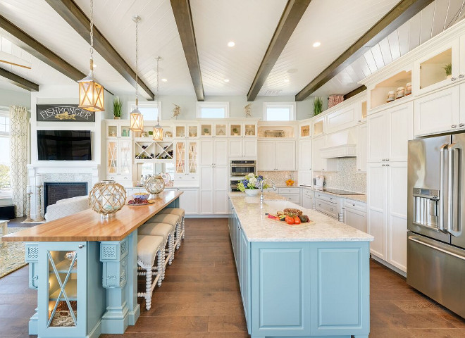 Coastal kitchen with blue turquoise island. The main living level is where you’ll find the massive kitchen with two oversized islands, a wet bar for entertaining and a dining nook surrounded by floor to ceiling windows letting in natural light and the surrounding views Coastal kitchen with blue turquoise island ideas. Coastal kitchen with blue turquoise island paint color #Coastalkitchen #blueisland #turquoiseisland Echelon Interiors