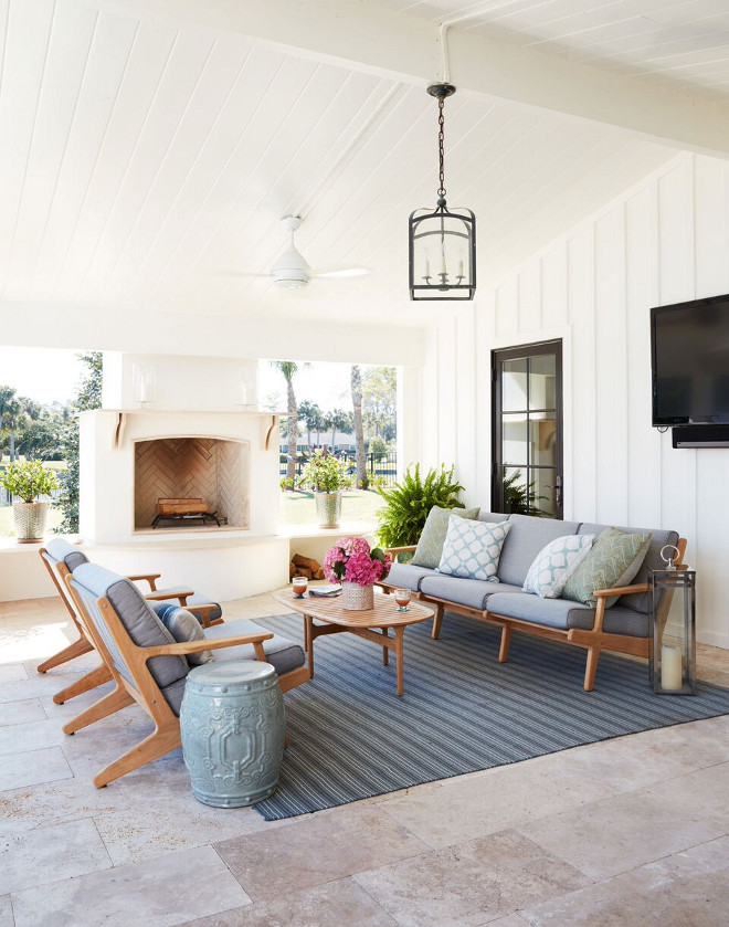 Creamy white porch with Limestone floor tile. Creamy white Paint Color is Benjamin Moore OC-17 White Dove. Neutral Creamy white porch with Limestone floor tile and outdoor fireplace #Creamywhiteporch #porch #Limestone #floortile #outdoorfireplace #CreamywhitePaintColor #BenjaminMooreOC17WhiteDove #BenjaminMooreOC17 #BenjaminMoore #WhiteDove Andrew Howard Interior Design