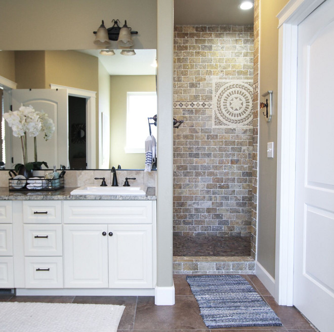 Doorless Shower. Lastly our shower is one of my favorite things about our home. I love how deep it goes back and It gives this busy mama a little bit of a spa feel at the end of the day. The tile work in our shower is Travertine. I chose this tile in here to correspond with our kitchen design. #DoorlessShower Home Bunch's Beautiful Homes of Instagram @AshleysDecorSpace_ 