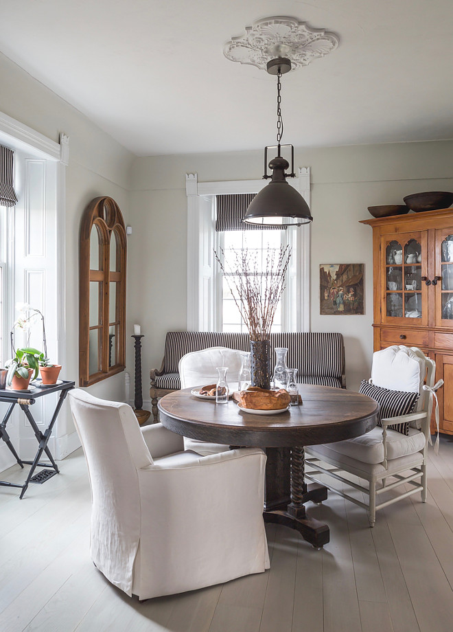 Farmhouse Dining Room. A chair may be in the dining room one day and the next day has a new home in another location… The bench shown in the dining room photo is the same one seen in another photo out on the porch. The cushions shown in the dining room photo are the same ones used outside for the summer on the corner bench. Home Bunch's Beautiful Homes of Instagram Cynthia Weber Design @Cynthia_Weber_Design