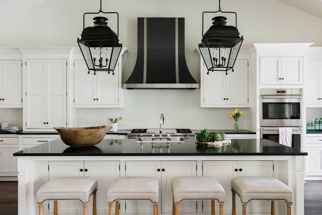 Farmhouse Kitchen. White farmhouse kitchen with black granite countertop and brick backsplash. White Farmhouse Kitchen. countertop and brick backsplash. Farmhouse Kitchen. White farmhouse kitchen with black granite countertop and brick backsplash #FarmhouseKitchen #Whitefarmhousekitchen #blackgranite #granitecountertop #countertop #brickbacksplash Curran & Co. Architects