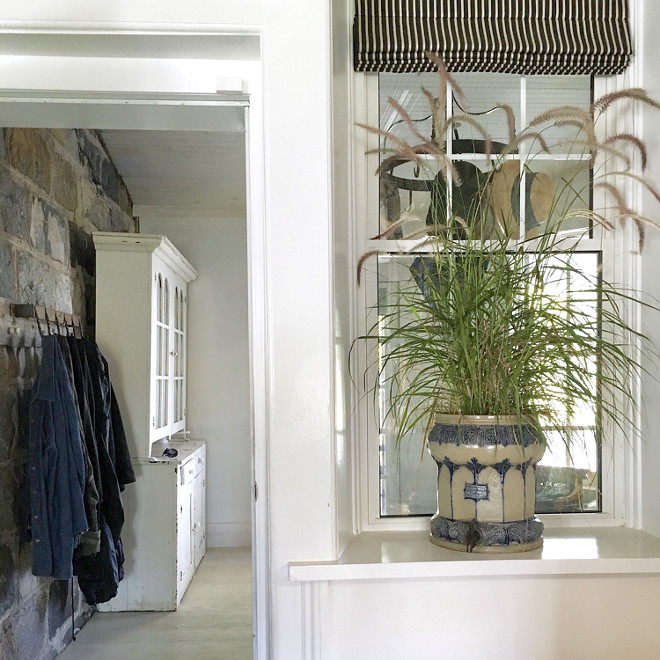 Farmhouse mudroom with stone accent wall. When we purchased the house it needed significant work. Various renovations throughout the decades had left it feeling slightly disjointed and in conflict with original architecture. Home Bunch's Beautiful Homes of Instagram Cynthia Weber Design @Cynthia_Weber_Design