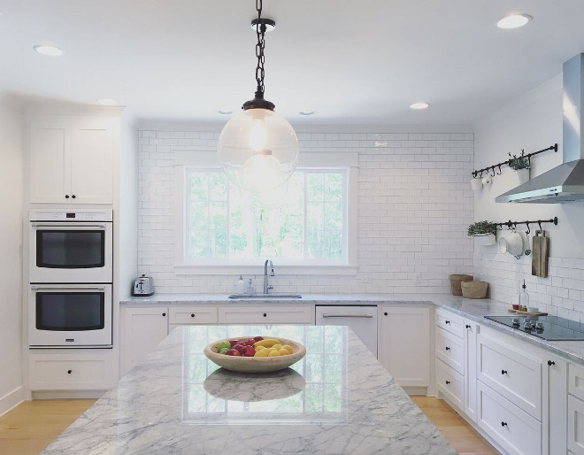 Forgoing the upper cabinets, I designed the kitchen with lots of deep drawers for dishes and cups, baking dishes, etc. Above the ovens are slots for baking sheets, muffin tins & cutting boards. Beautiful Homes of Instagram @theclevergoose