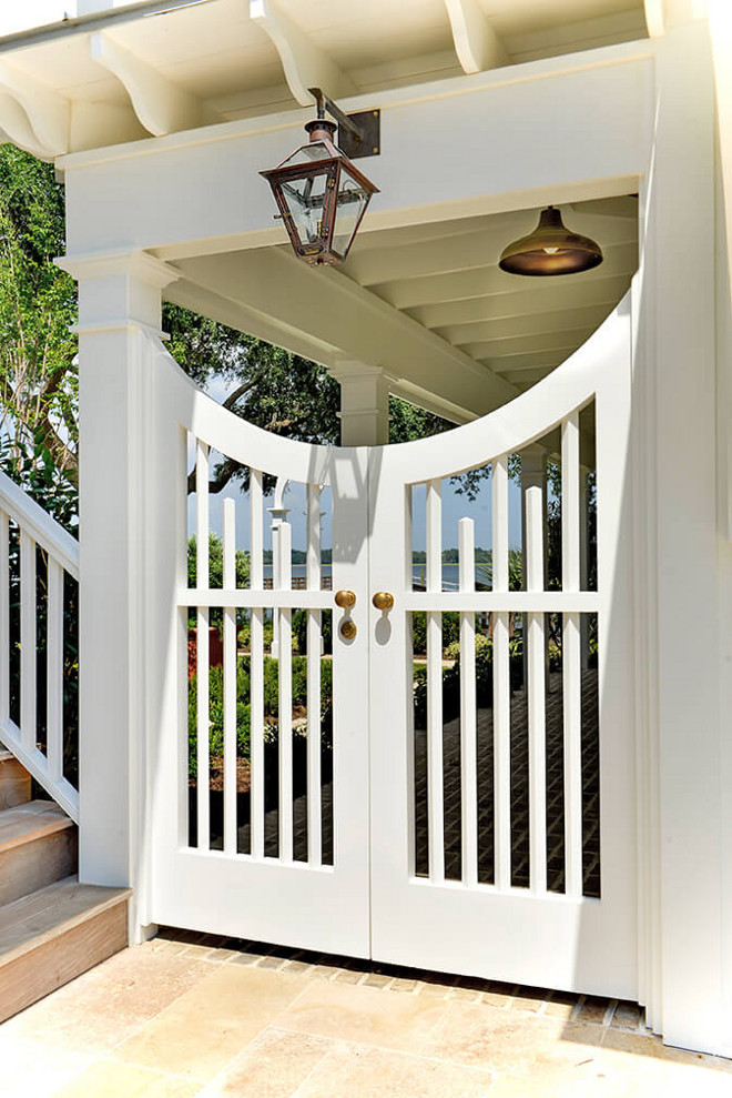 Garden Gate. Custom garden gate painted in Sherwin Williams Pure White. Garden gate lighting is by Bevolo #gardengate #garden #gate #whitegate #sherwinwilliamspurewhite Robyn Hogan Home Design