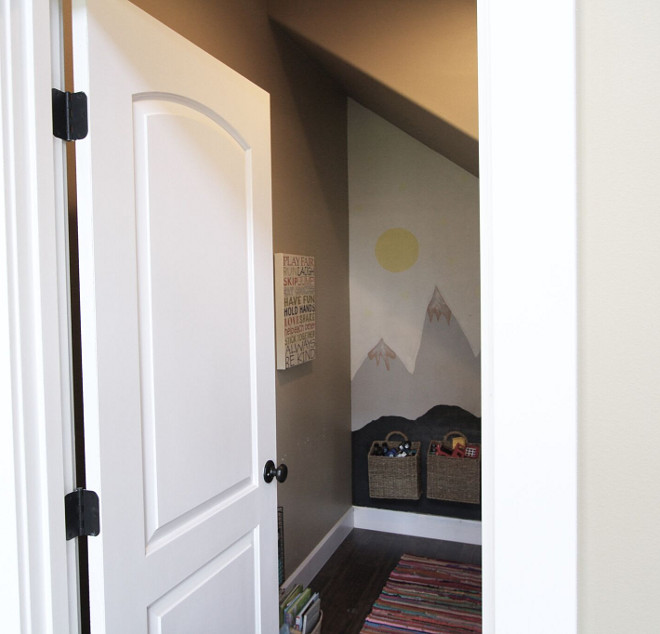 Kids Toy Storage Playroom under stairs. Another thing I love about our great room is this storage closet beneath the stairs. It’s not only a home to one of the 5 murals that I painted in our home, but it's also where all the toys live. I love it because the kids enjoy it and know where to find their things. It’s easy to clean up and close the door when people come over or just at the end of the night. Plus it forces me to limit the amount of toys we somehow collect. I only keep really what we can fit into this closet space. We absolutely LIVE in this space in our home mainly because of this closet. Bye bye toy clutter! Home Bunch's Beautiful Homes of Instagram @AshleysDecorSpace_ 