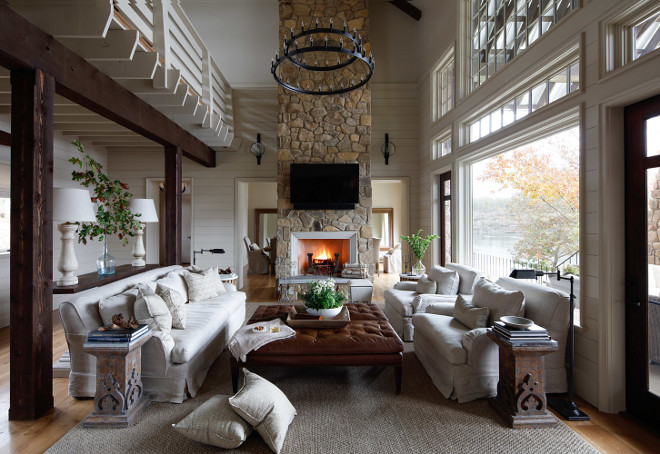 Lake House Interiors. Lake House Interiors. Lake house living room with high ceilings, shiplap walls, floor-to-ceiling stone fireplace and slipcovered furniture. Lake House Interiors. Lake House Interiors #LakeHouseInteriors #LakeHouse #Interiors Christopher Architecture & Interiors