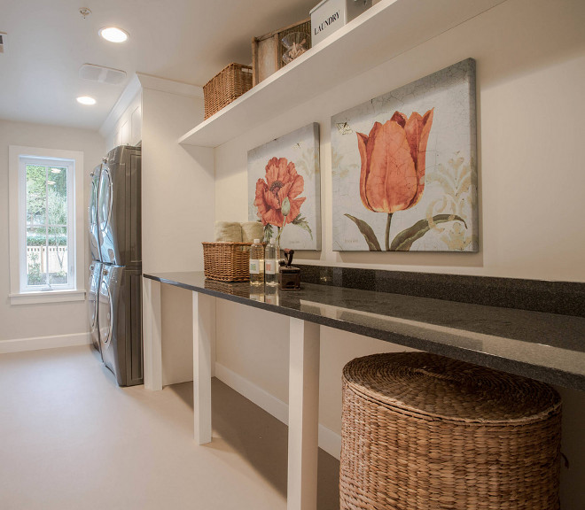 Laundry room features two pairs stacked washer and dryer and a long countertop for folding. This narrow laundry room features two pairs of stacked washer and dryer and a long countertop for folding. This narrow and long laundry room features two pairs of stacked washer and dryer and a long countertop for folding. Calista Interiors