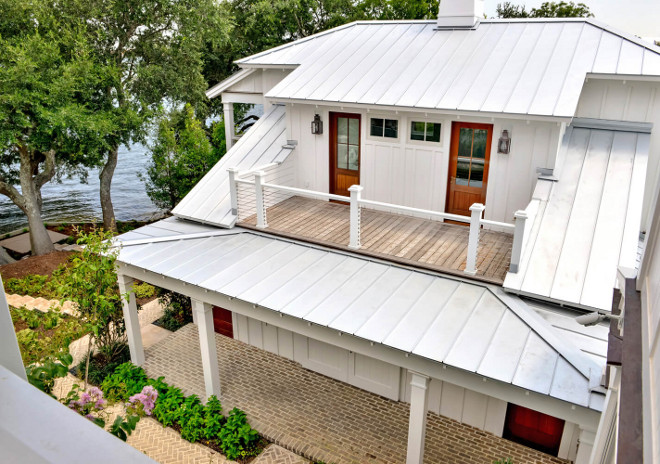 Metal Roof. Home exterior with board and batten siding, ipe wood deck, stainless steel cable railing, brick patio and metal roof. Galvanized Metal roof is by Galvalume. Robyn Hogan Home Design