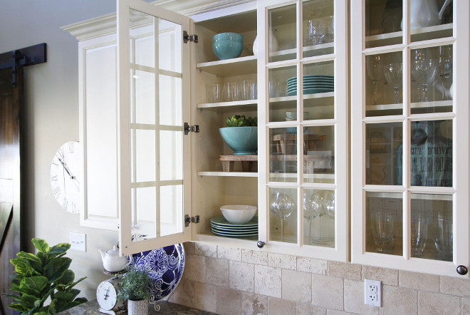 Off white kitchen cabinet with glass doors and rubbed oil bronze hardware. Hardware is Allen & Roth hardware from Lowes. Home Bunch's Beautiful Homes of Instagram @AshleysDecorSpace_ 