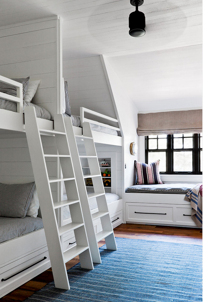 Side by Side Bunk Beds with Shiplap Trim. Bunk room features white ladders mounted on side by side built-in bunk beds accented with shiplap trim. Shiplap Bunk Room. Side by Side Bunk Beds with Shiplap Trim. Side by Side Bunk Beds with Shiplap Trim #Shiplap #Bunkroom #SidebySideBunkBeds #Shiplap #ShiplapTrim