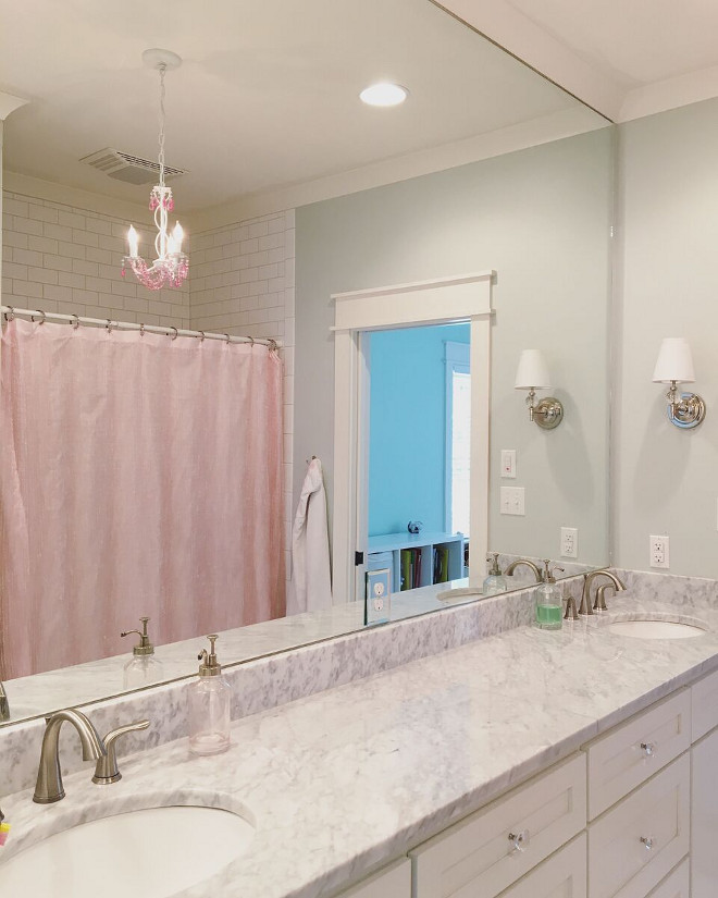 The nearly 10' long vanity was designed with a cabinet under each sink and a stack of drawers to the side. The sinks were installed close to each wall to allow for plenty of room on the opposite side (between the two sinks) for hair dryers, and other primping necessities. Beautiful Homes of Instagram @theclevergoose