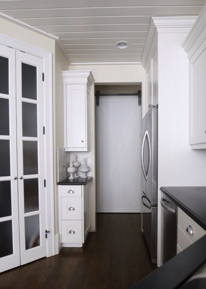 The pass through from the kitchen leads to our laundry. Adding a custom built barn door freed up space as one passes from kitchen to laundry. Home Bunch's Beautiful Homes of Instagram @cambridgehomecompany