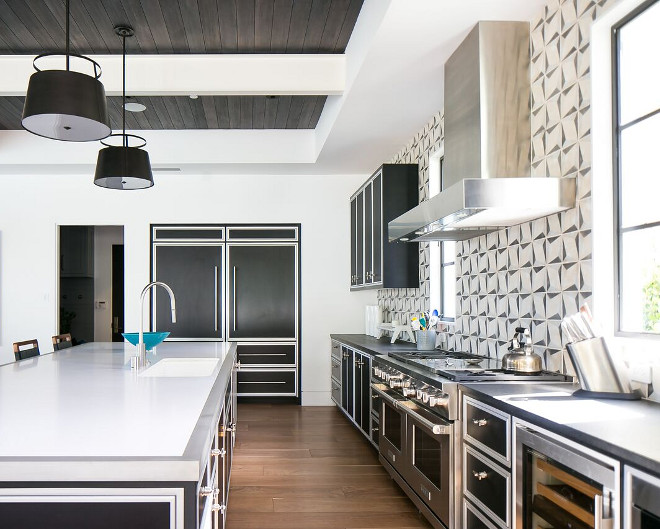 Transitional Kitchen Countertop. Kitchen Island Countertop: Brushed Finish Stainless Steel. Island countertop is white quartz with stainless steel trim. Perimeter countertop is leathered black granite. Patterson Custom Homes