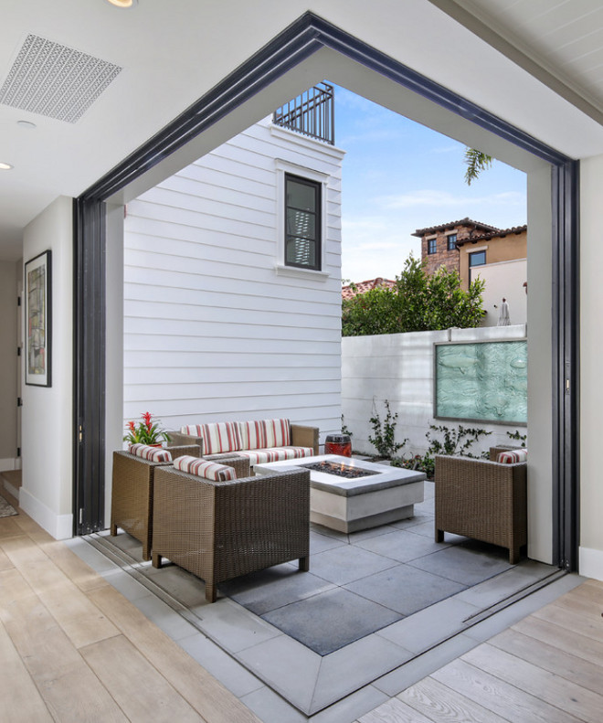 Steel door pocket sliders open up to the courtyard off of the great room creating an indoor/outdoor living space. The doors conceal inside the wall on both ends, enlarging the feel of the home. Patterson Custom Homes