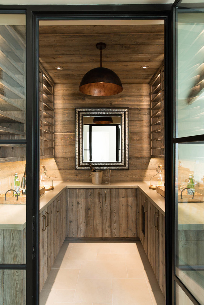 Wine cellar. Farmhouse wine cellar. Barnwood shiplap wine cellar with steel sash doors, concrete countertops and reclaimed barn wood cabinets. #winecellar #Barnwoodshiplap #winecellardesign #farmhousewinecellar #steelsashdoors #concretecountertops #reclaimedbarnwoodcabinets #barnwoodcabinets Holder Design Associates