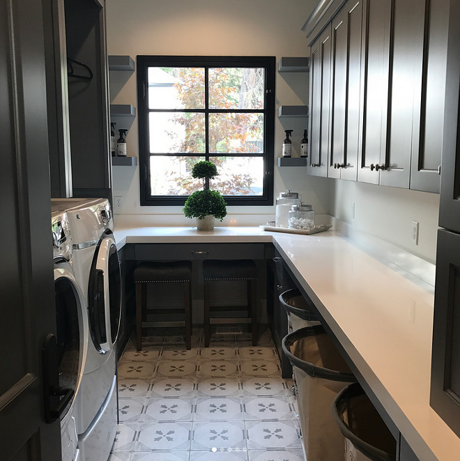 Laundry room with charcoal gray cabinets, white quartz countertop and black window. Laundry room with charcoal gray cabinets, white quartz countertop and black window. Laundry room with charcoal gray cabinets, white quartz countertop and black window. Laundry room with charcoal gray cabinets, white quartz countertop and black window #Laundryroom #charcoalgraycabinets #whitequartz #countertop #blackwindow Tree Haven Homes. Danielle Loryn Design