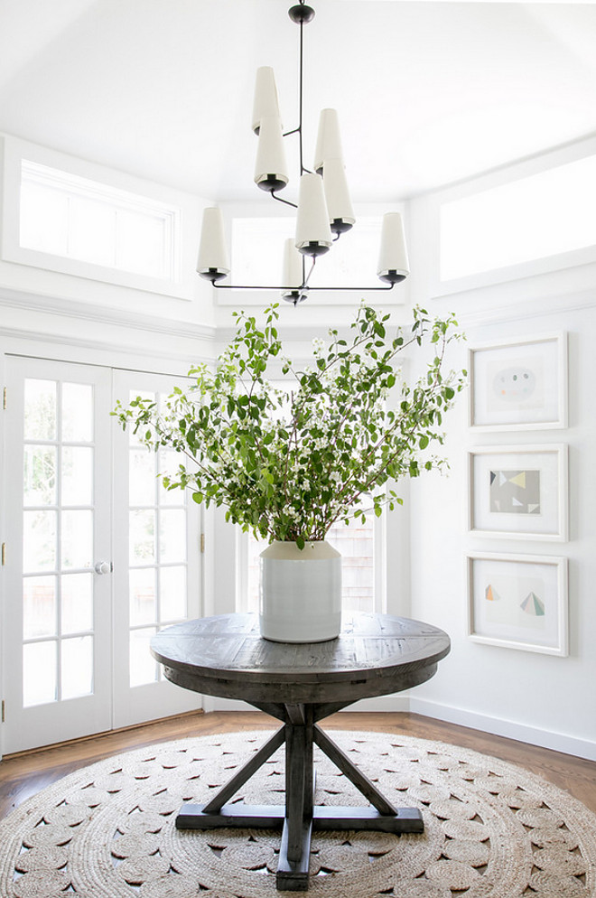 Modern Farmhouse Foyer. Modern Farmhouse Foyer features round driftwood table and modern chandelier from Circa Lighting #foyer #modernfarmhouse #farmhousefoyer #farmhouse #circalighting #modernchandelier Chango & Co.