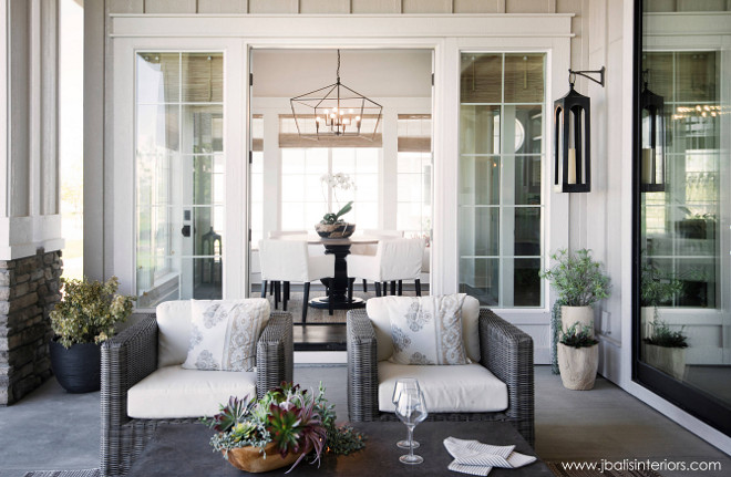 Back porch. Kitchen dining area opens to covered back porch with comfortable outdoor furniture and beautiful decor. Judith Balis Interiors