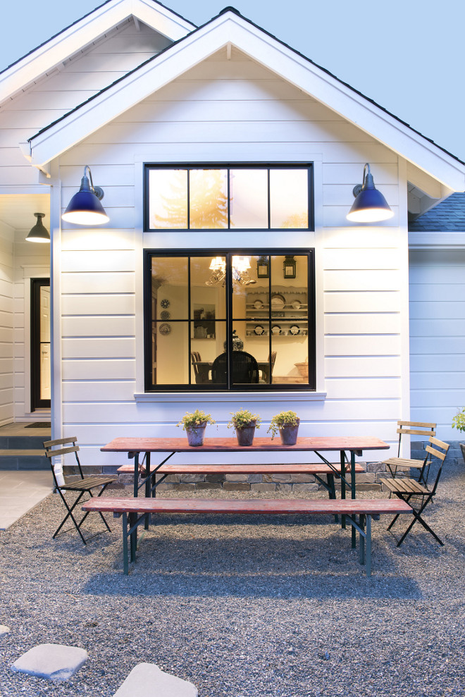 Black Windows. White farmhouse exterior with Black Windows and barn lighting. Black Windows #BlackWindows #farmhouse #farmhousewindows #farmhouseexterior #farmhouseexteriorwindows Tama Bell Design